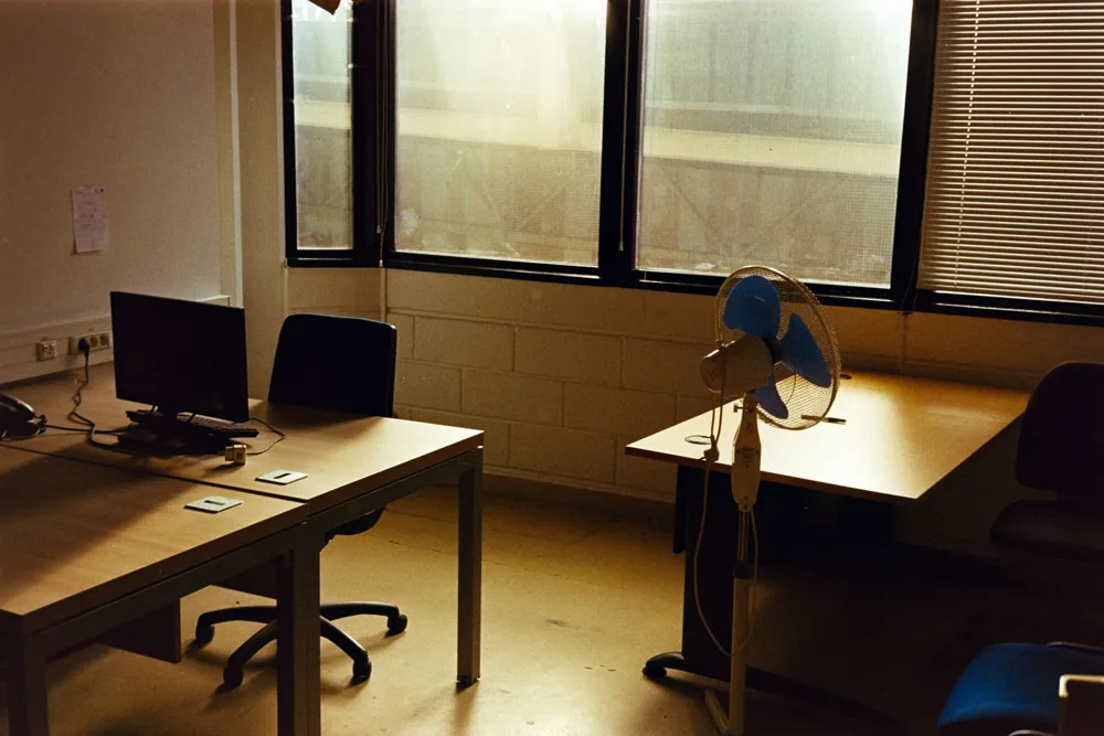 Stock photo: quiet tidy office with a desk and computer in afternoon light